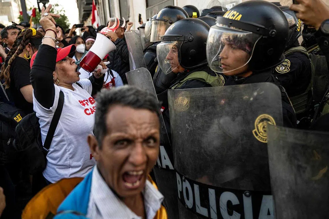 People opposing the government of Peruvian President Pedro Castillo face the police during a demonstration to demand his resignation in Lima, on Nov 5, 2022. 