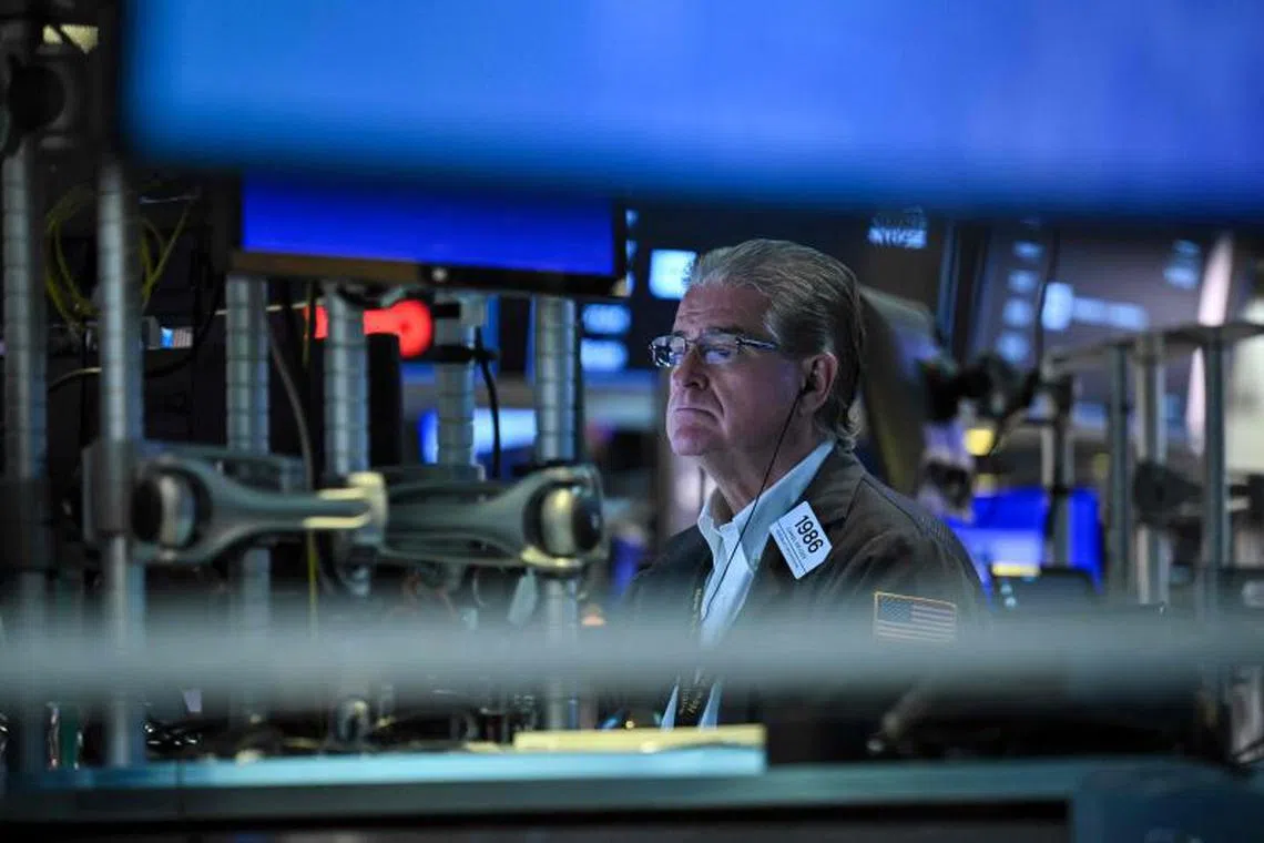 A traders works on the floor of the New York Stock Exchange (NYSE) during morning trading on August 4, 2025, in New York City. Wall Street stocks bounced Monday after a steep sell-off last week, as optimism for an earlier central bank interest rate cut prevailed while investors digested a government report indicating weakness in the jobs market. (Photo by ANGELA WEISS / AFP)