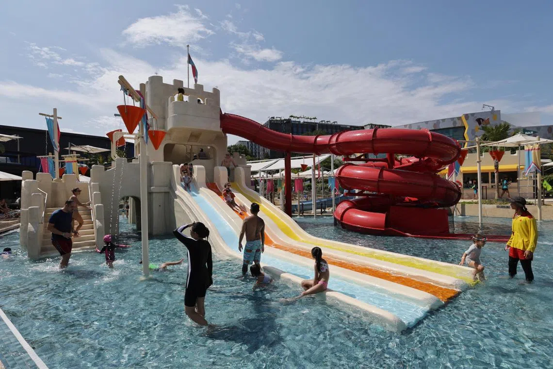ST20230827_202323130366 : Gin Tay/ edsep/ Eddino Abdul Hadi/
 Aira Eddino, (in black) 10, playing at Spash Tribe, a water play area complete with slides and plunge pools, Aug 27, 2023.
///The newly opened beach front destination Palawan @ Sentosa by Shangri-La features activities such as an electric go-kart circuit, HyperDrive, an 18-hole mini golf course, as well as a water play area complete with slides and plunge pools.