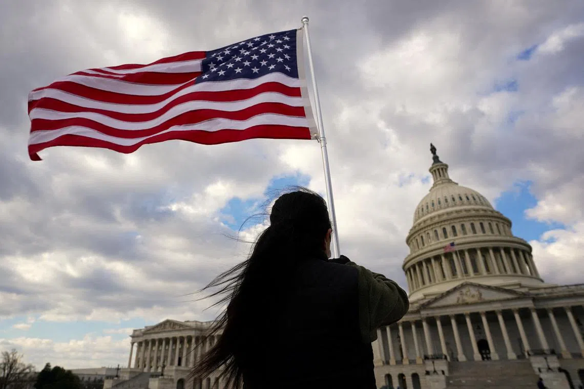A person holds a flag aloft at the US Capitol in Washington on Feb 6, 2023.