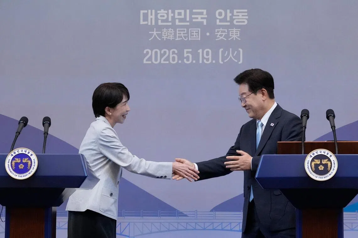 Japanese Prime Minister Sanae Takaichi shaking hands with South Korean President Lee Jae Myung at a meeting in Andong on May 19.