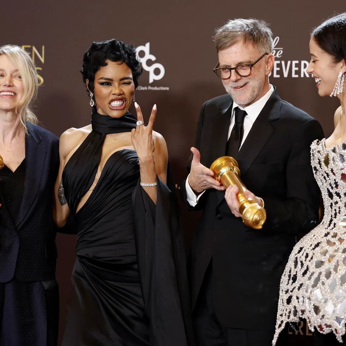 (From left) US film producer Sara Murphy, US singer and actor Teyana Taylor, US film-maker Paul Thomas Anderson, and US actor Chase Infiniti pose with the award for best motion picture - musical or comedy for One Battle After Another during the 83rd annual Golden Globe Awards ceremony.