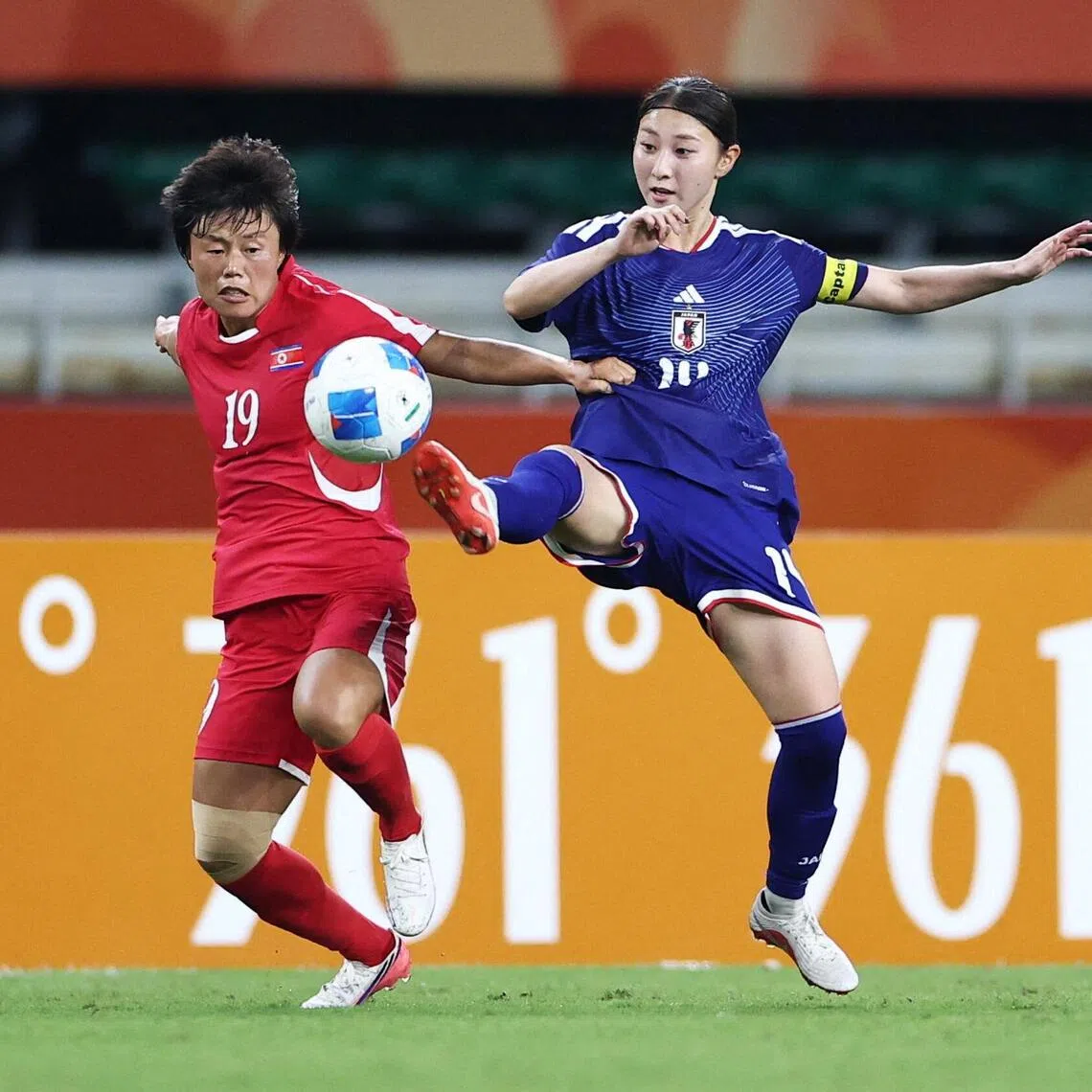 Japan’s Shiokoshi Yuzuho fighting for the ball with North Korea’s Choe Kum Ok in the Asian Games women’s football final at Shizuoka Stadium on Oct 2.