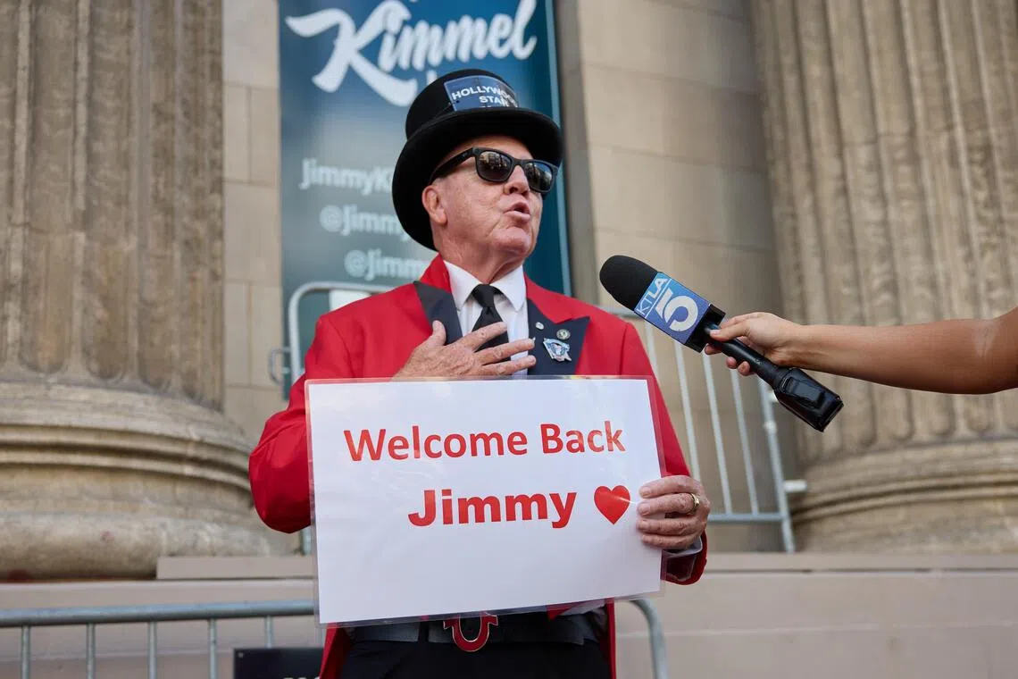 Actor Gregg Donovan is interviewed as he holds a sign welcoming back Jimmy Kimmel in Los Angeles, California.
