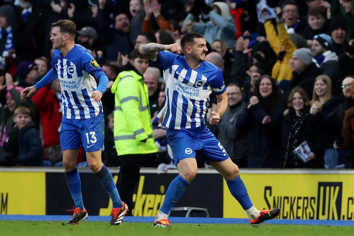 Lewis Dunk celebrates scoring the equaliser for Brighton and Hove Albion, with Pascal Gross.