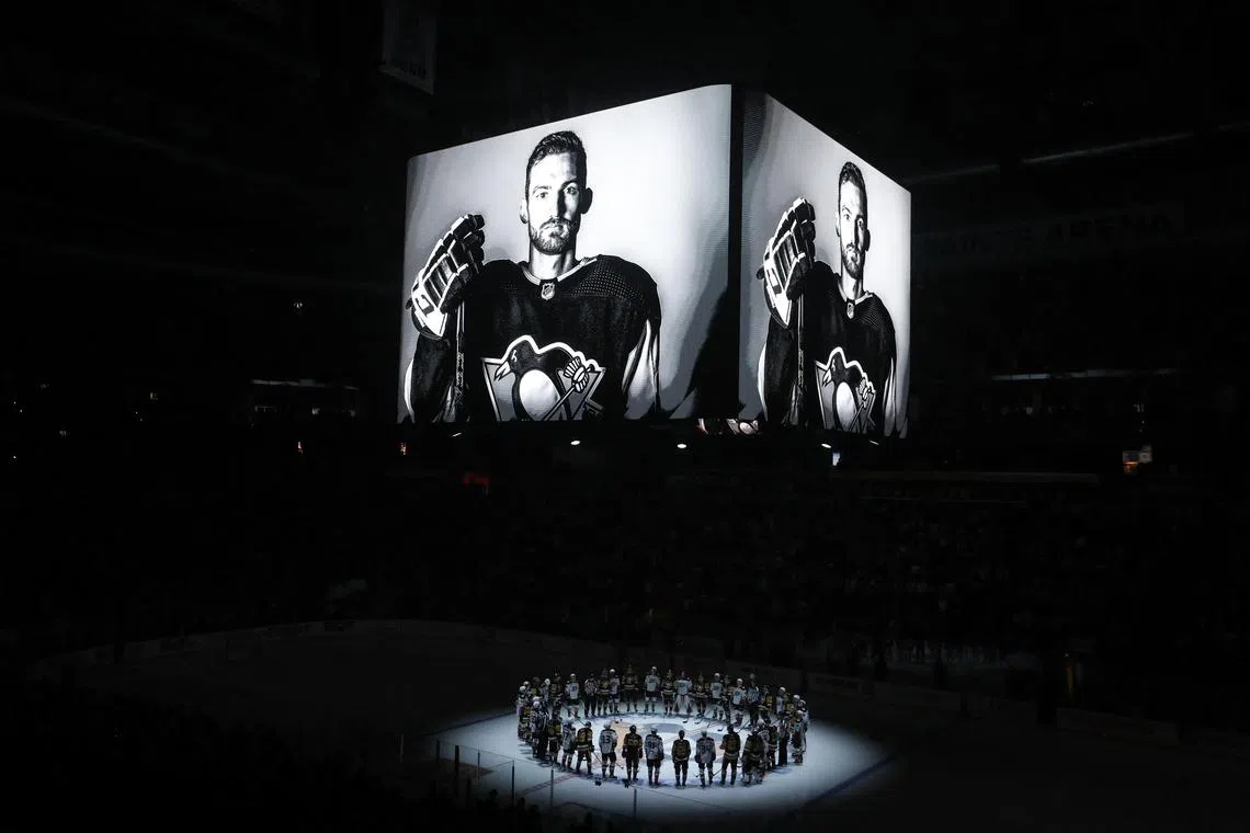 Members of the Anaheim Ducks and the Pittsburgh Penguins stand at centre ice for a moment of silence at the PPG Paints Arena to honor former Penguin forward Adam Johnson who was tragically killed in a hockey-related accident in Sheffield.