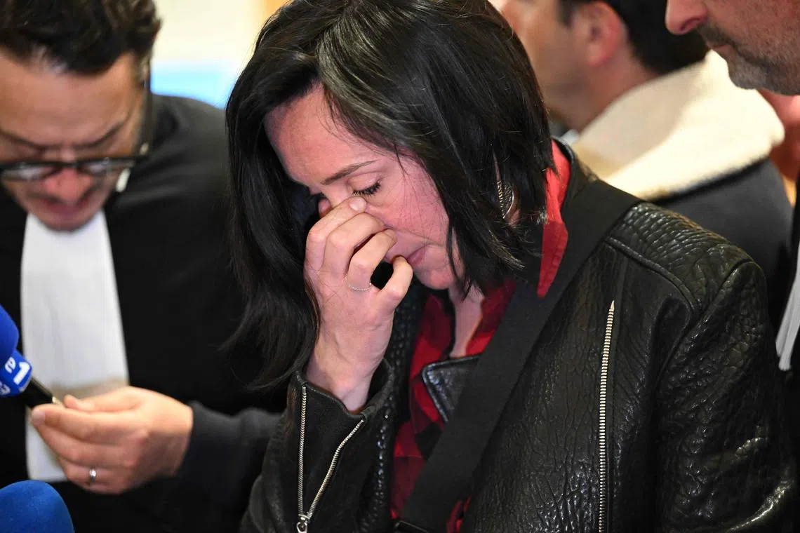 Ophelie Toulliou, sister of a victim of a crash, reacts at the Paris courthouse, on April 17, 2023.