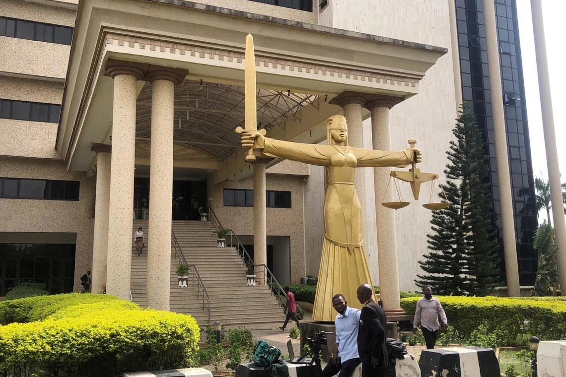 FILE PHOTO: Journalists wait outside the Federal High Court in Abuja, Nigeria June 29, 2021. REUTERS/Afolabi Sotunde/File Photo