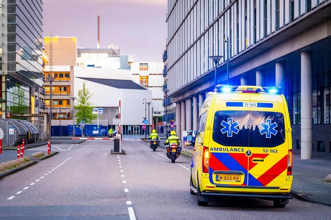An ambulance part of a convoy allegedly carrying at least one of the passengers from the cruise ship MV Hondius believed to be infected with hantavirus escorted by Dutch police on motorcycles as it arrives near Leiden University Medical Center.