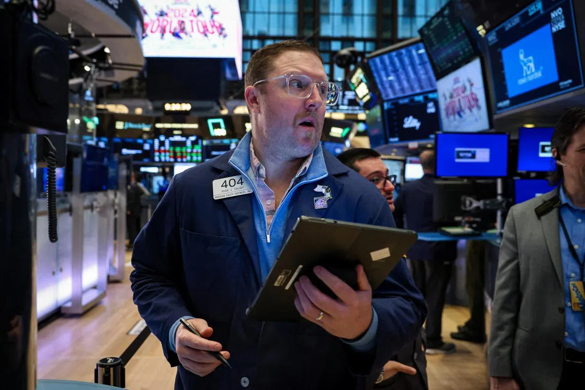 Traders work on the floor of the New York Stock Exchange, in New York City.
