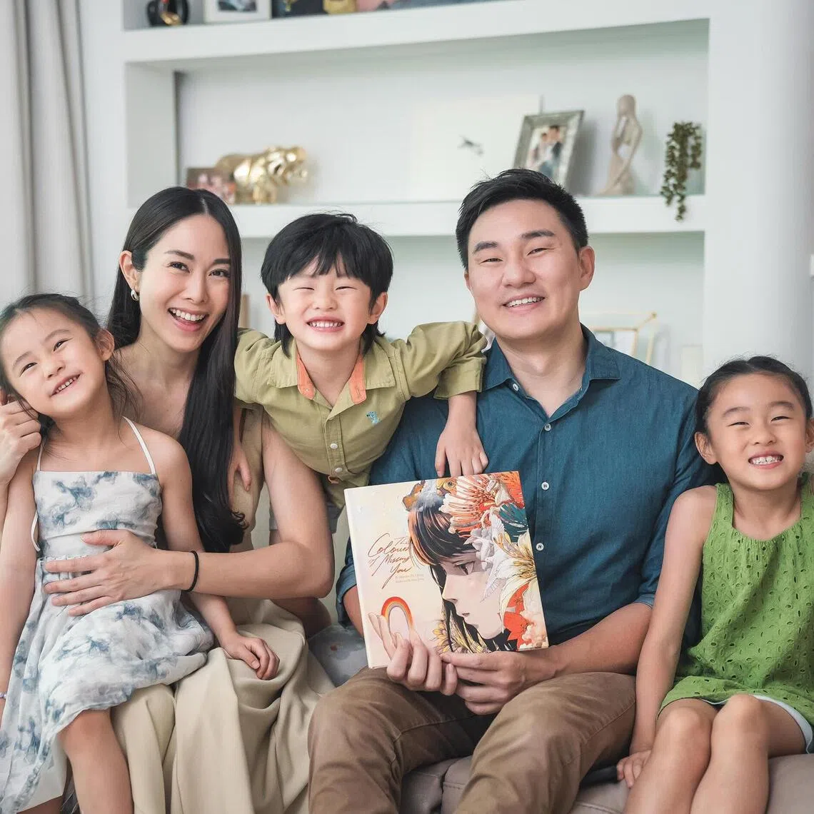 Mr Darren Cheng, chief executive of Direct Funeral Services, has authored a new book The Colours Of Missing You, which aims to help kids comprehend loss and grief. He is seen here with his wife Jenny Tay and their three kids.