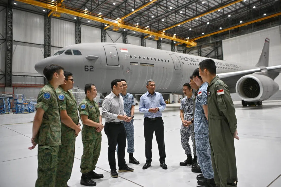 Minister for Foreign Affairs, Dr Vivian Balakrishnan, and Senior Minister of State for Defence, Mr Zaqy Mohamad, meet the RSAF mission crew at Changi Air Base (East) on Nov 29, 2023. 