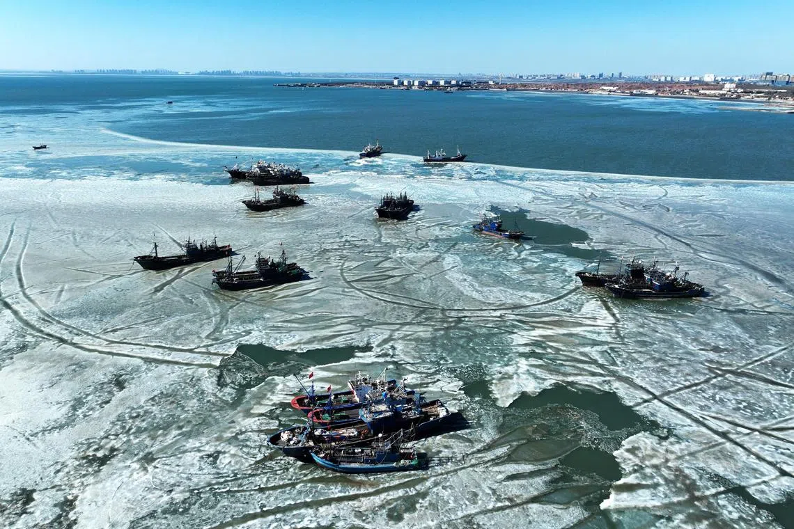 Fishing boats are surrounded by sea ice in Jiaozhou bay, in Qingdao, in China’s eastern Shandong province on February 8, 2025. (Photo by AFP) / China OUT