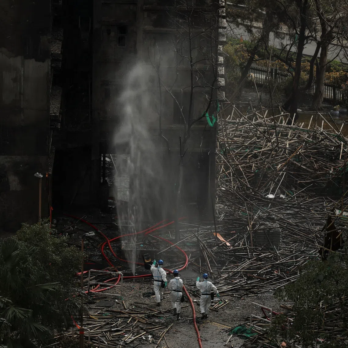 Police officers with the Disaster Victim Identification Unit at the scene of the deadly fire at the Wang Fuk Court complex in Tai Po on Dec 1.