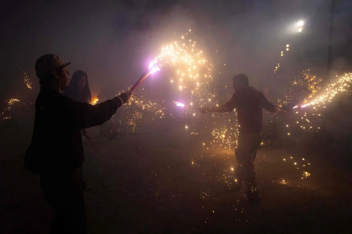 Local residents lighting firecrackers during the celebrations of the Chinese New Year in Macau on Feb 21, 2026. 