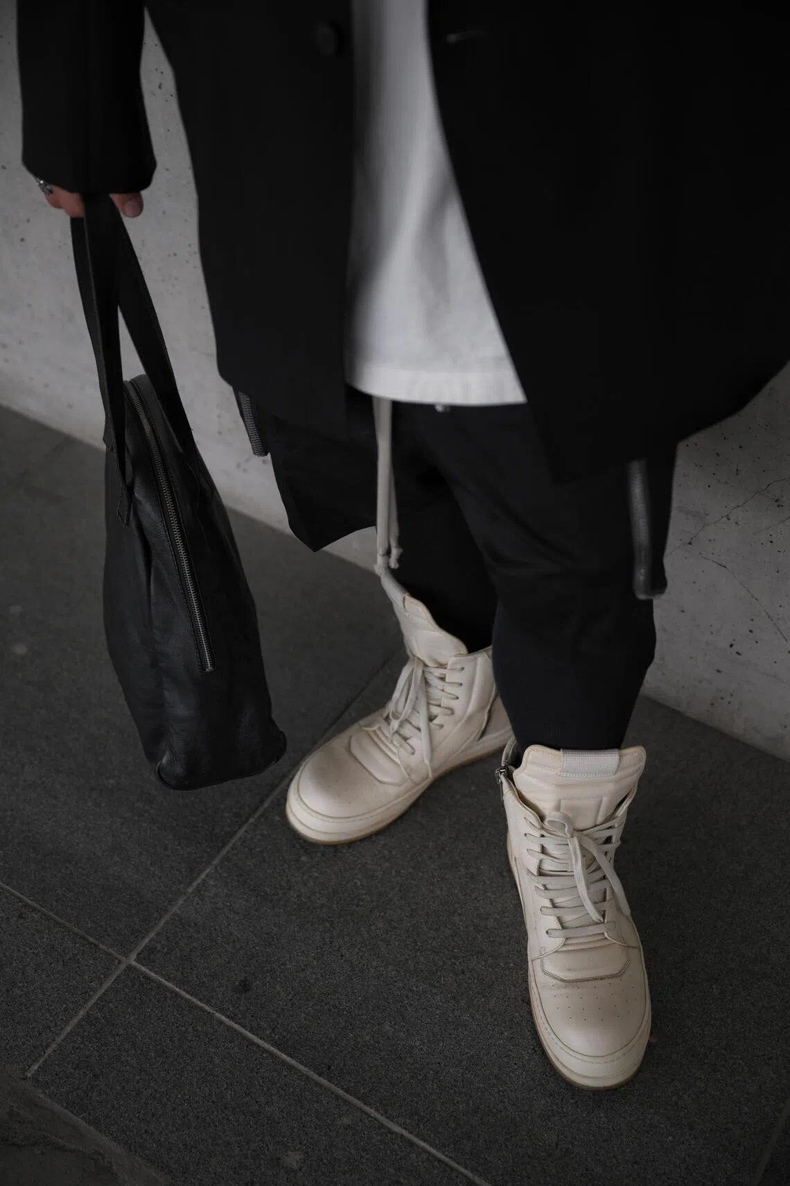 Mr Roger Tan’s outfits often hinge on contrast – black layers offset with white sneakers and elongated hems.