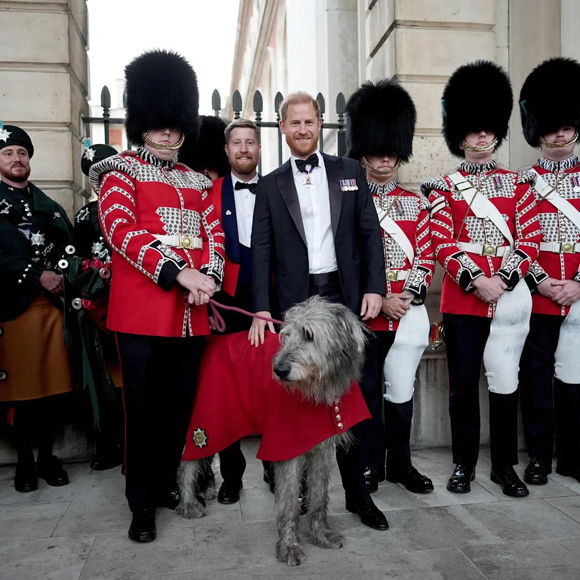 Britain’s Prince Harry, Duke of Sussex poses with members of the Band of the Irish Guards and their mascot, Irish wolfhound dog ‘Seamus’, as he attends the inaugural Invictus Spirit Awards at the Old Royal Naval College in Greenwich, London.