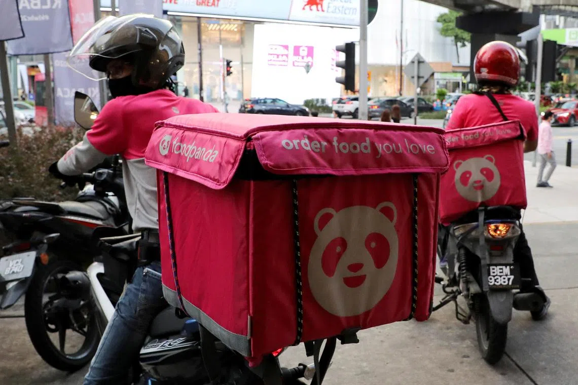 A 2020 photo showing Foodpanda riders getting ready to make deliveries outside a restaurant in Kuala Lumpur, Malaysia.