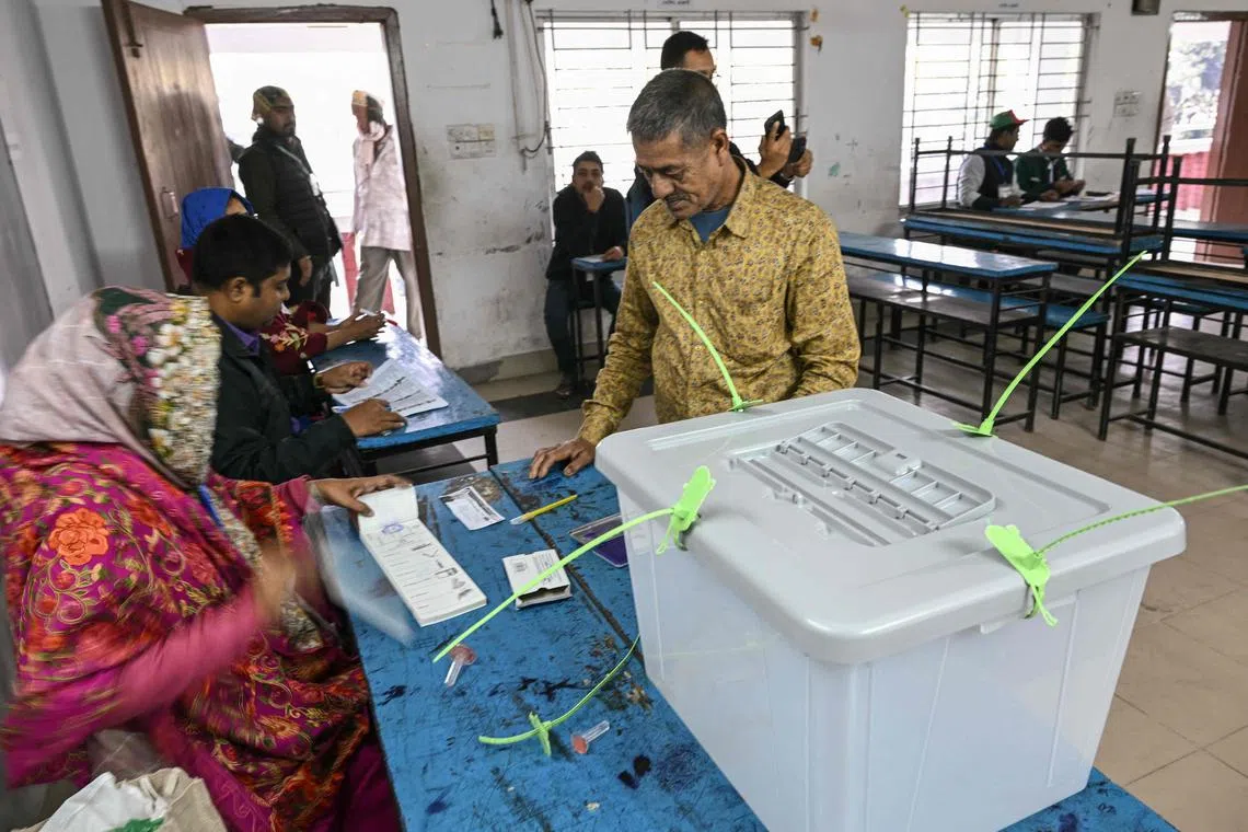A man waits to receive his ballot paper before voting in Bangladesh's general election in Dhaka on Jan 7.