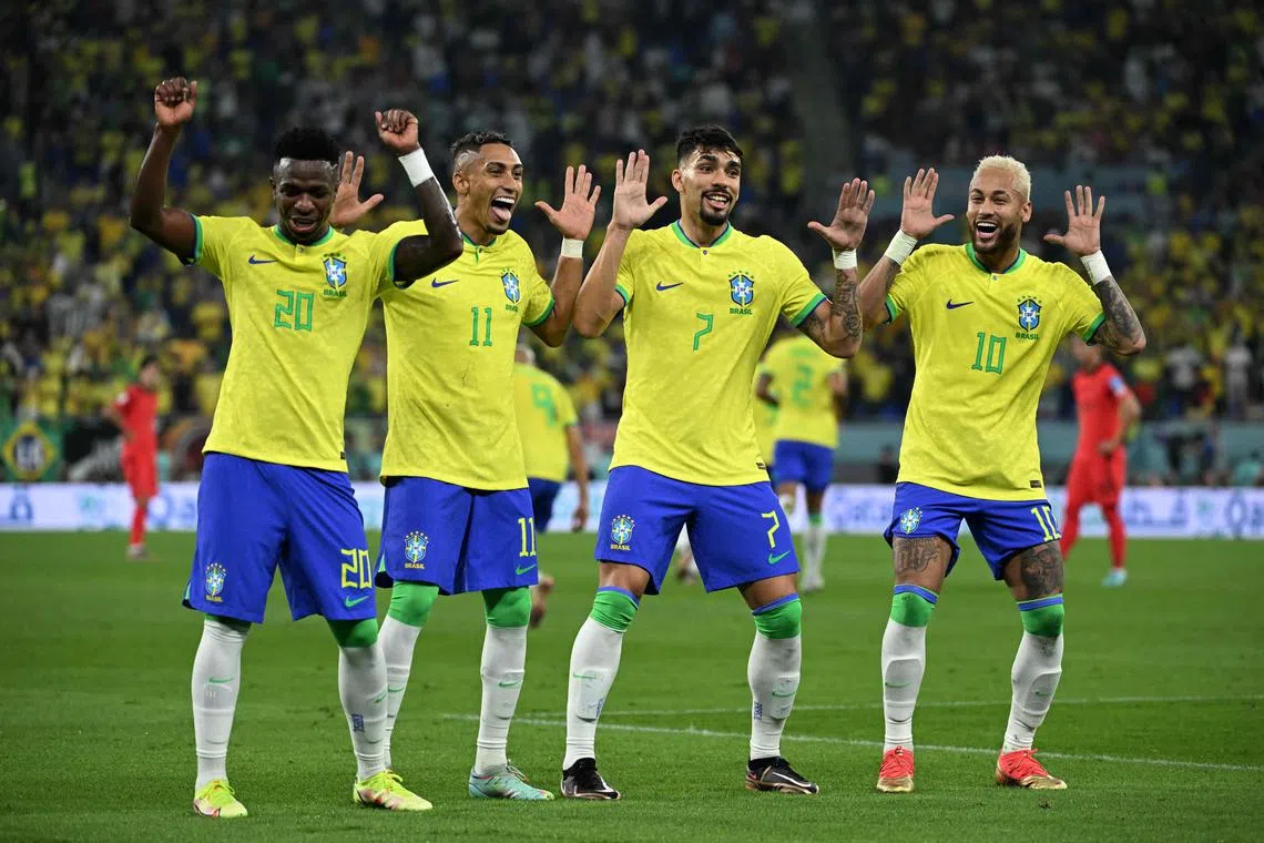Brazil's Vinicius Jr (No. 20) celebrating scoring his team's first goal with Lucas Paqueta and Neymar during their 4-1 win over South Korea on Dec 5.