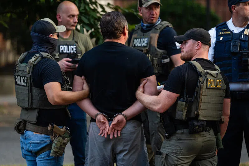  Immigration and Customs Enforcement officers and a Homeland Security Investigations agent arrest a man at a “safety checkpoint” in the Navy Yard in Washington, on Aug 15.