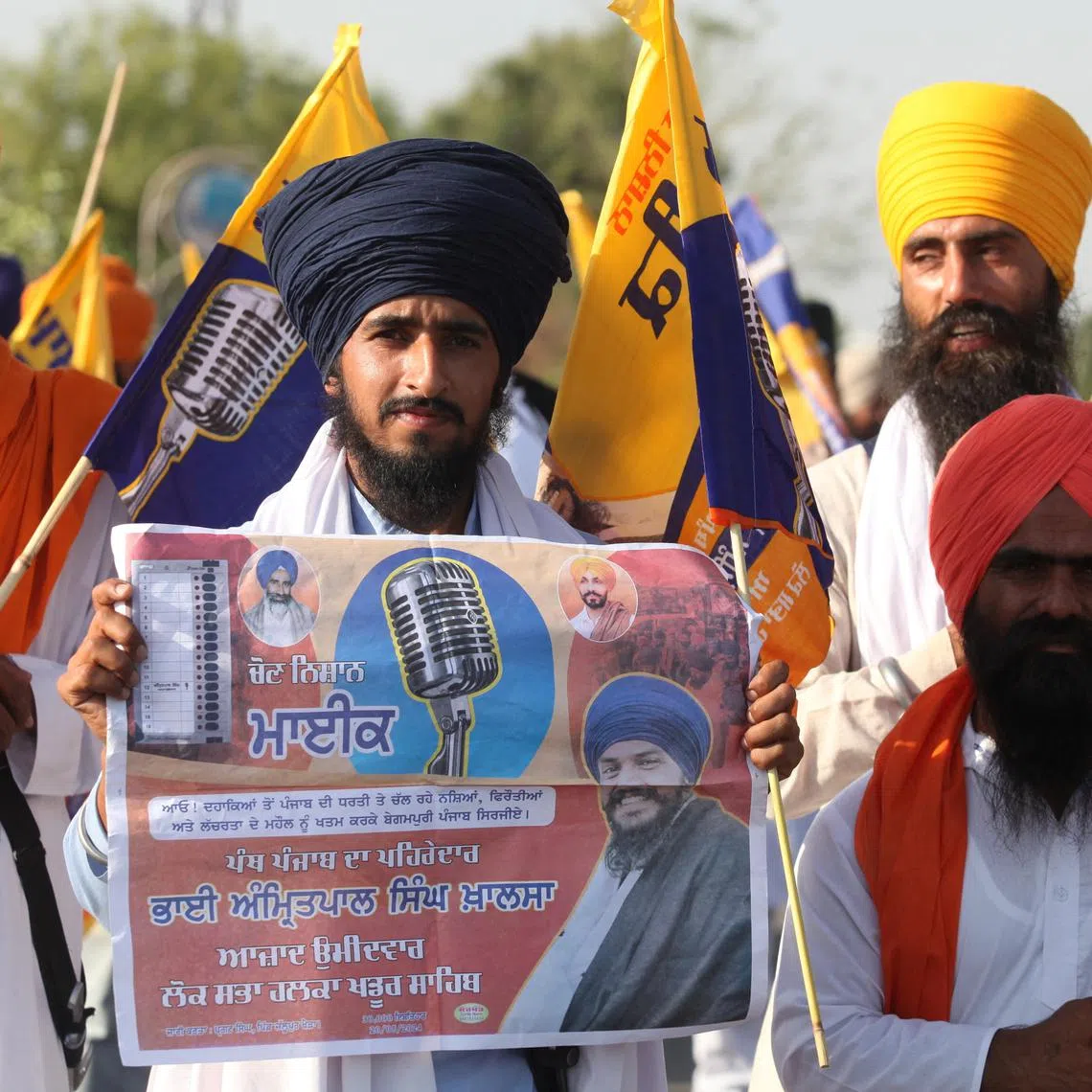 A supporter of Sikh separatist leader Amritpal Singh, an independent candidate from Khadoor Sahib constituency, holds an election campaign poster of Amritpal, in Tarn Taran district, Punjab, India, May 28, 2024. REUTERS/Munish Sharma