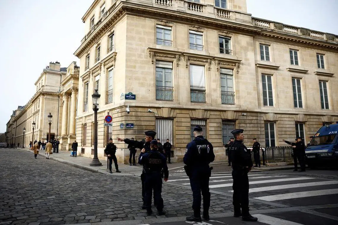 French police stand in position near the National Assembly as protesters gather before the start of a debate on the immigration law in Paris, France, December 11, 2023. REUTERS/Sarah Meyssonnier