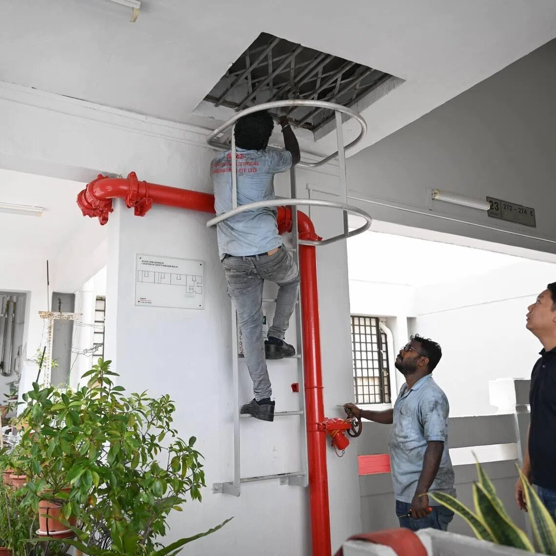 Workers accessing at Block 269B Queen Street on March 20, after a blackout hit the block.
