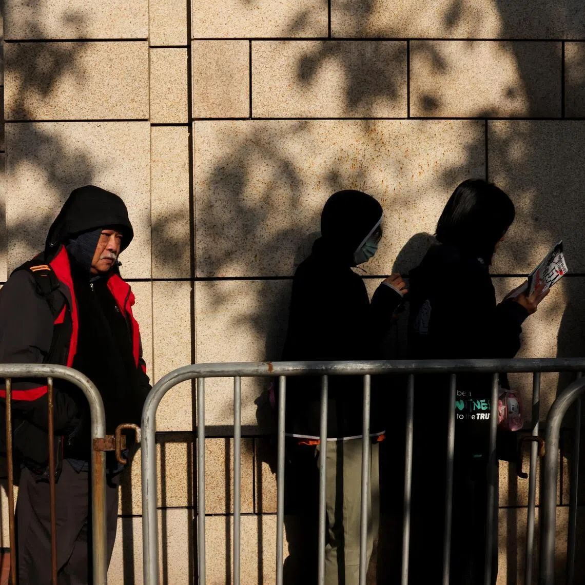 People queue to enter the West Kowloon Magistrates' Courts building for sentencing in the national security collusion trial of Jimmy Lai, founder of the now-defunct pro-democracy newspaper Apple Daily, in Hong Kong, China, February 9, 2026.