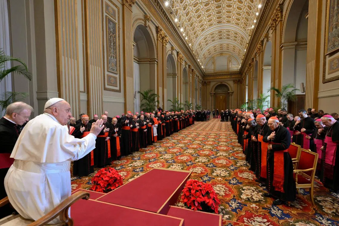 Pope Francis greeting his key collaborators "Roman Curia" in Vatican City on Dec 21. 