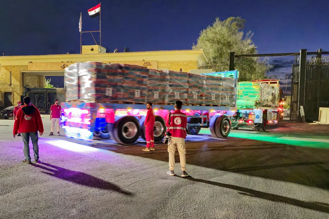 FILE PHOTO: Trucks carrying aid bound for Gaza cross the border crossing between Egypt and the Gaza Strip, after a ceasefire between Israel and Hamas in Gaza went into effect, in Rafah, Egypt, October 12, 2025. REUTERS/Stringer/File Photo