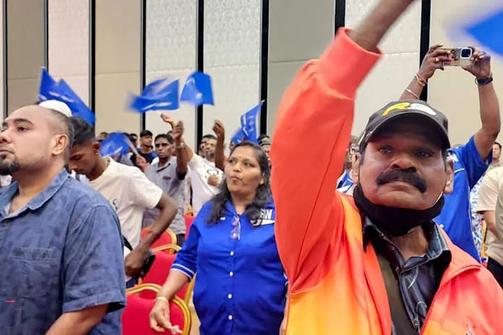 Indian supporters wave Barisan Nasional flags during a meeting with BN chief Zahid Hamidi on July 25 during a political rally in Port Dickson, Negeri Sembilan.