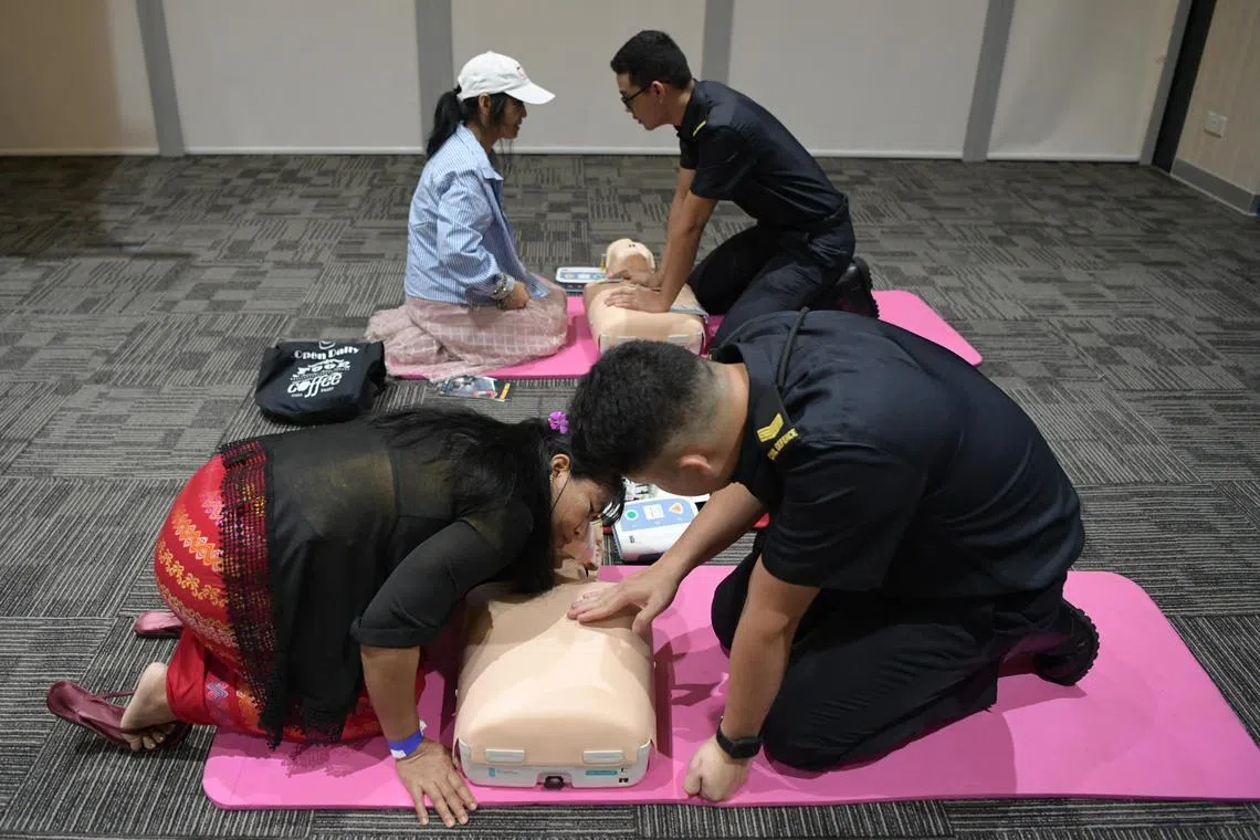 CPR skills being taught at a booth run by the SCDF as part of NTUC May Day Domestic Employees Celebration 2023 on June 18, 2023.