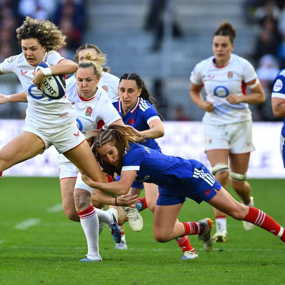 England's full-back Ellie Kildunne is tackled by France's scrum-half Pauline Bourdon Sansus as she runs with the ball in the Women's Six Nations international rugby union match at the Stade Atlantique in Bordeaux on May 17, 2026.