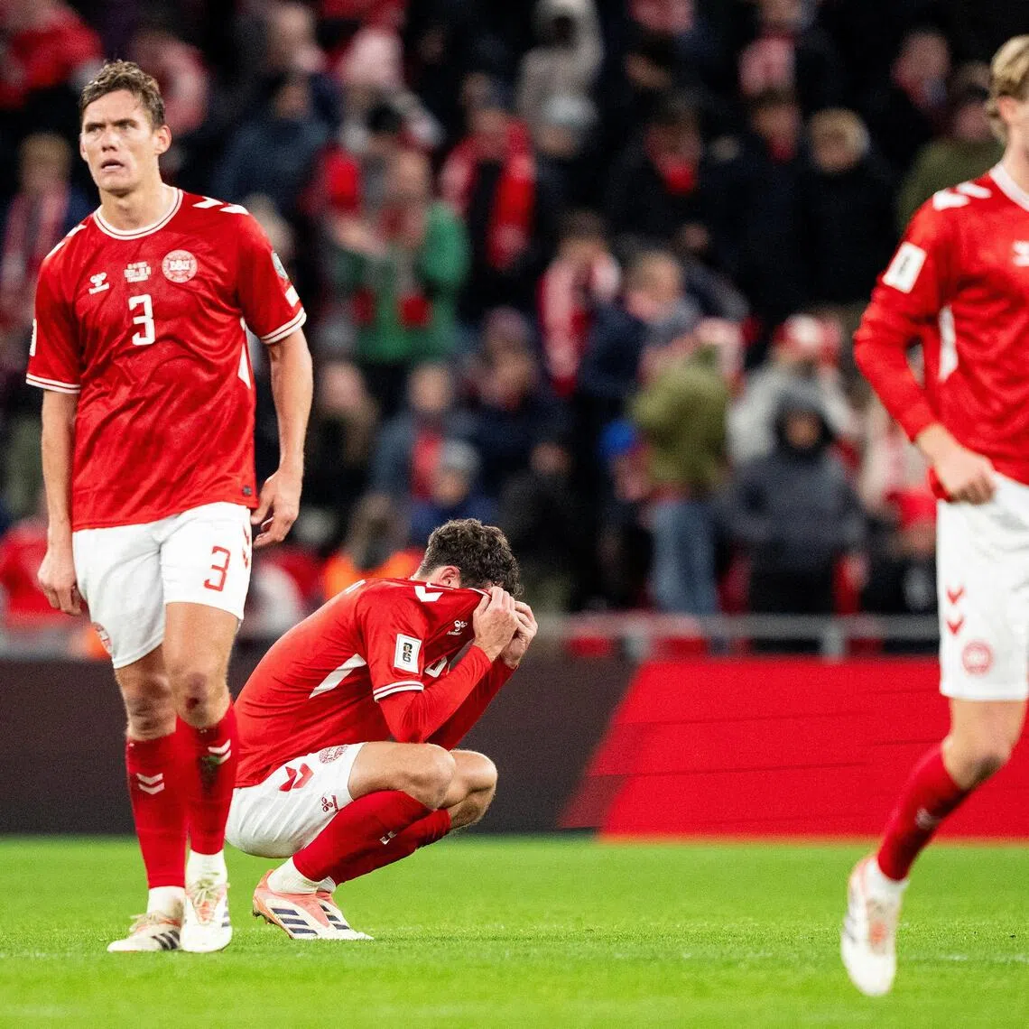 Denmark's Jannik Vestergaard and Andreas Christensen look dejected after the 2-2 World Cup qualifying draw with Belarus in Copenhagen on Nov 15, 2025.
