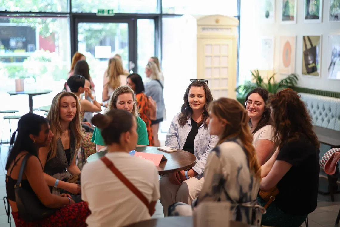 People attend "The Girlies Club", a networking event that brings together people looking for rental flatmates in London.
