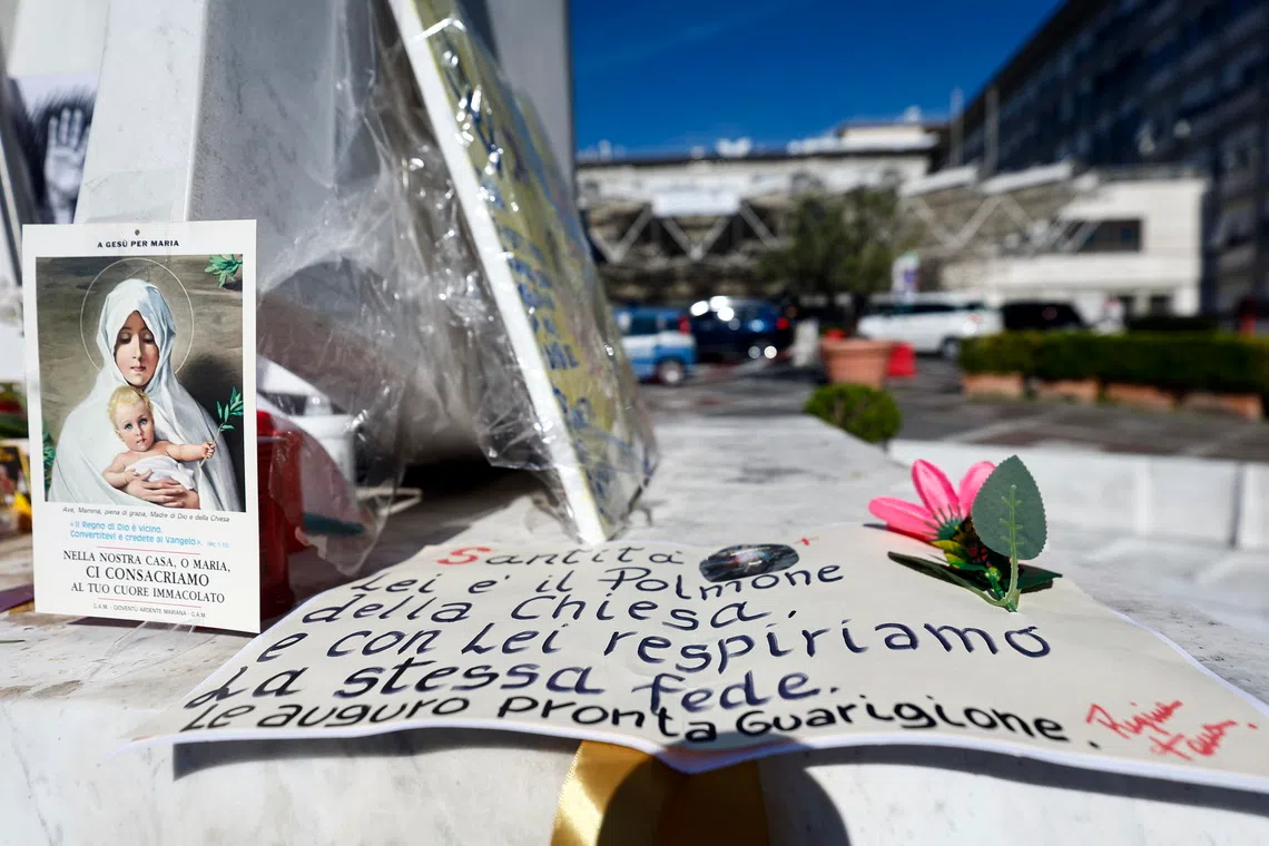 Messages for Pope Leo XIV are placed at the foot of Pope John Paul II’s statue in front of the Agostino Gemelli University Hospital, where Pope Leo XIV is hospitalied in Rome, Italy.