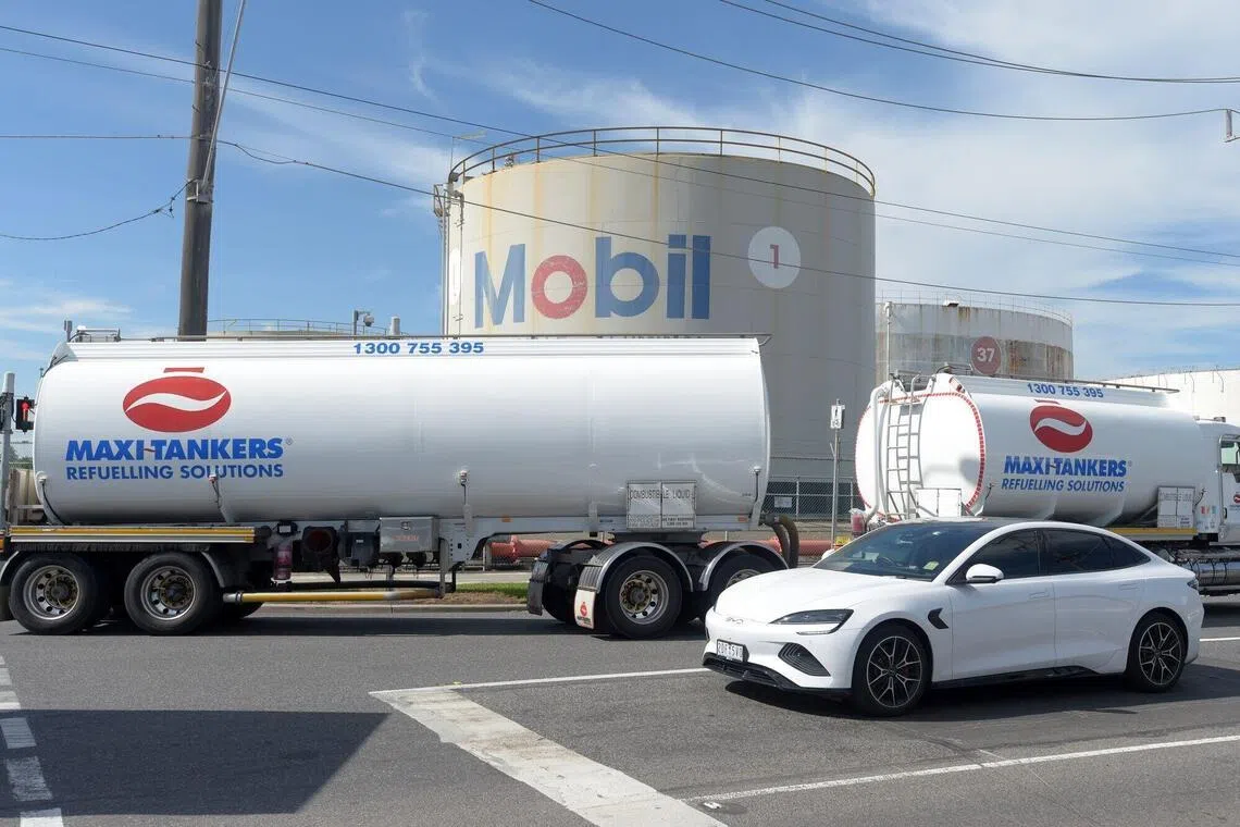 A Maxi-Tankers fuel tanker passes a fuel storage tank at the ExxonMobil Yarraville Terminal in Spotswood, Australia, on March 31, 2026. 