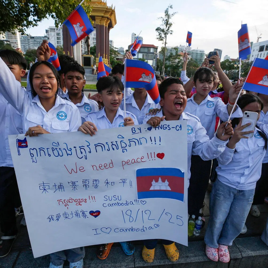 Cambodians take part in a march to call for a truce in fighting along the Thai-Cambodian border.

