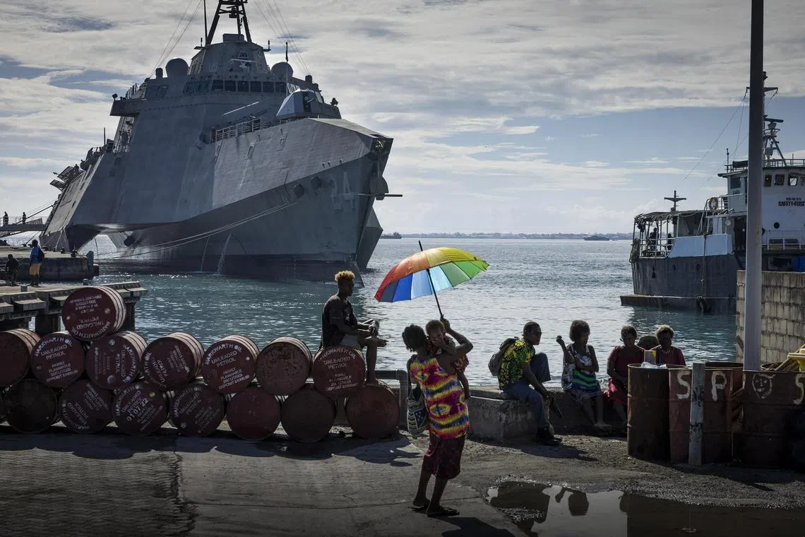 U.S. combat ship Oakland stationed by the harbor in Honiara, Solomon Islands, on Sunday, Aug. 7, 2022, where a crowd gathered to watch the memorial service. At a ceremony to mark the 80th anniversary of a crucial battle in the Pacific, two daughters of men who served there reflected on the lessons of war. (Matthew Abbott/The New York Times)