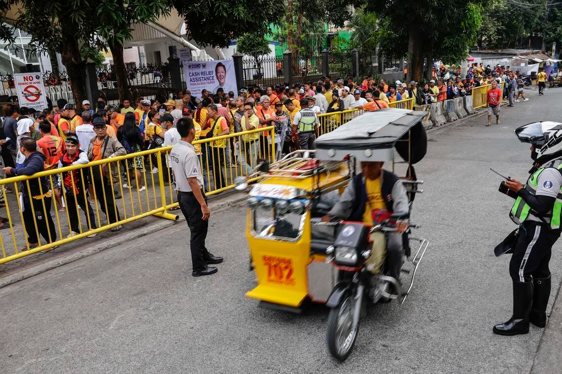 Tricycle drivers queue to receive a government subsidy distributed at a public park in Quezon City, Metro Manila, Philippines, on 17 March 2026.