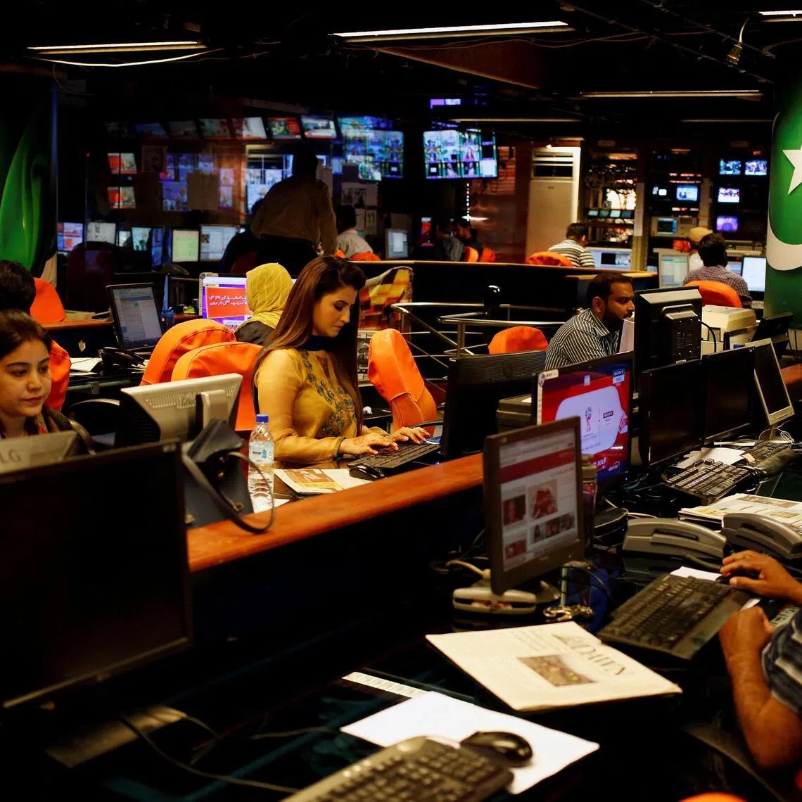 Employees working at the newsroom of Geo News television channel in Karachi, Pakistan.