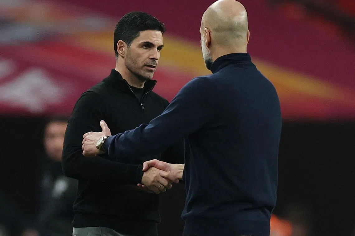 Soccer Football - Carabao Cup - Final - Arsenal v Manchester City - Wembley Stadium, London, Britain - March 22, 2026 Manchester City manager Pep Guardiola shakes hands with Arsenal manager Mikel Arteta after winning the Carabao Cup Action Images via Reuters/Paul Childs EDITORIAL USE ONLY. NO USE WITH UNAUTHORIZED AUDIO, VIDEO, DATA, FIXTURE LISTS, CLUB/LEAGUE LOGOS OR 'LIVE' SERVICES. ONLINE IN-MATCH USE LIMITED TO 120 IMAGES, NO VIDEO EMULATION. NO USE IN BETTING, GAMES OR SINGLE CLUB/LEAGUE/PLAYER PUBLICATIONS. PLEASE CONTACT YOUR ACCOUNT REPRESENTATIVE FOR FURTHER DETAILS..