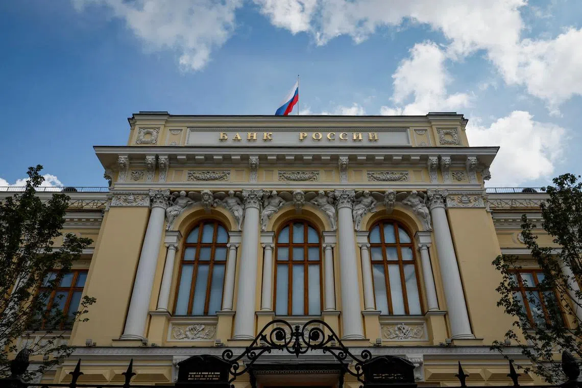 FILE PHOTO: A Russian state flag flies over the Central Bank headquarters in Moscow, Russia, August 15, 2023. A sign reads: \"Bank of Russia\". REUTERS/Shamil Zhumatov/File Photo