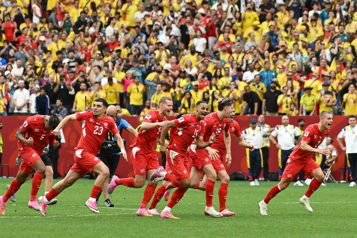 Switzerland players celebrate after winning the penalty shoot-out against Colombia on July 7.