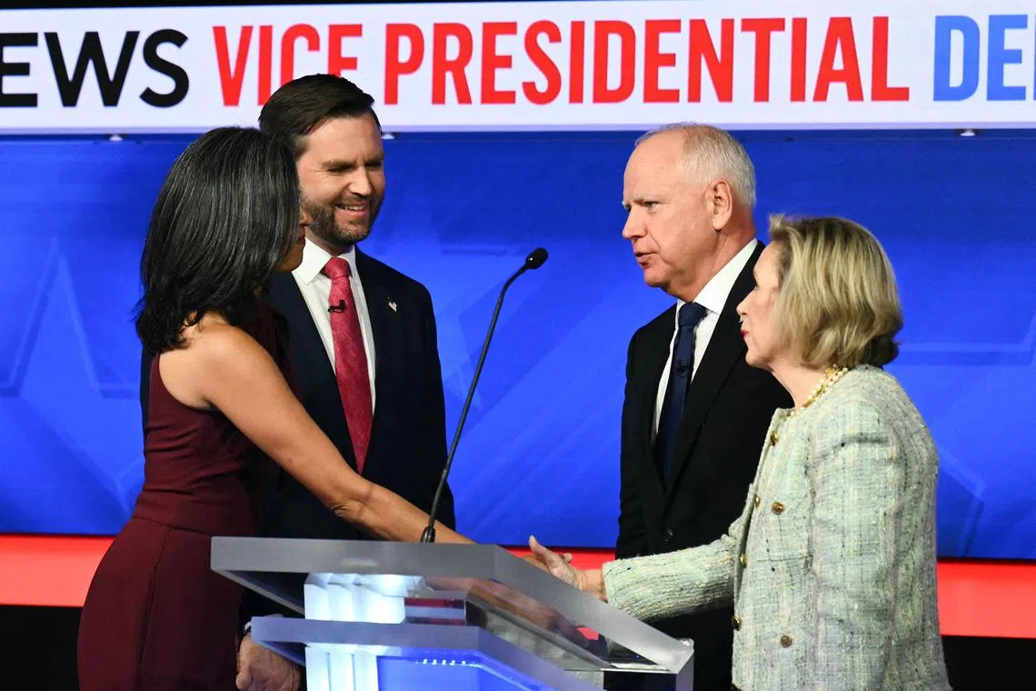 TOPSHOT - (L-R) US Senator and Republican vice presidential candidate J.D. Vance and his wife Usha Vance greet Minnesota Governor and Democratic vice presidential candidate Tim Walz and his wife Gwen Walz at the end of the Vice Presidential debate hosted by CBS News at the CBS Broadcast Center in New York City on October 1, 2024. (Photo by ANGELA WEISS / AFP)