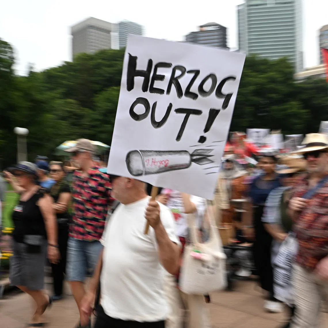 A man holds a placard during a protest on Feb 1 against Israeli President Isaac Herzog's upcoming visit to Australia.