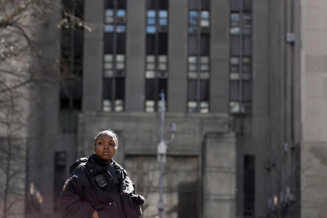 A New York Police officer guards the Manhattan Criminal Court, where former president Donald Trump is set to make an appearance on Tuesday.
