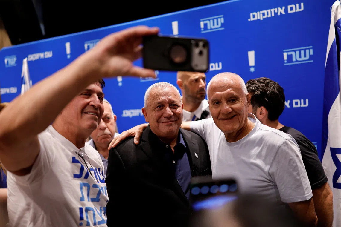 FILE PHOTO: Supporters take a selfi with Israeli opposition leader and former Israeli military chief Gadi Eisenkot at a conference ahead of Israel's national election, in Dimona, Israel, July 6, 2026. REUTERS/Amir Cohen/ File Photo