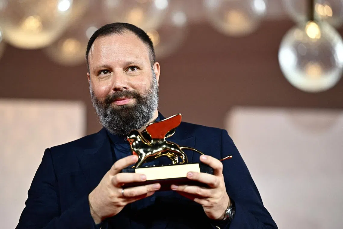 Poor Things director Yorgos Lanthimos poses with the Golden Lion for Best Film.